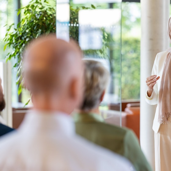 Woman speaking to a group of people.